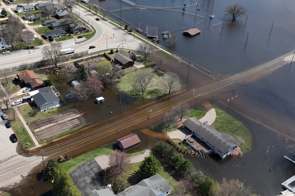 Aerial view of a river flooding a town.
